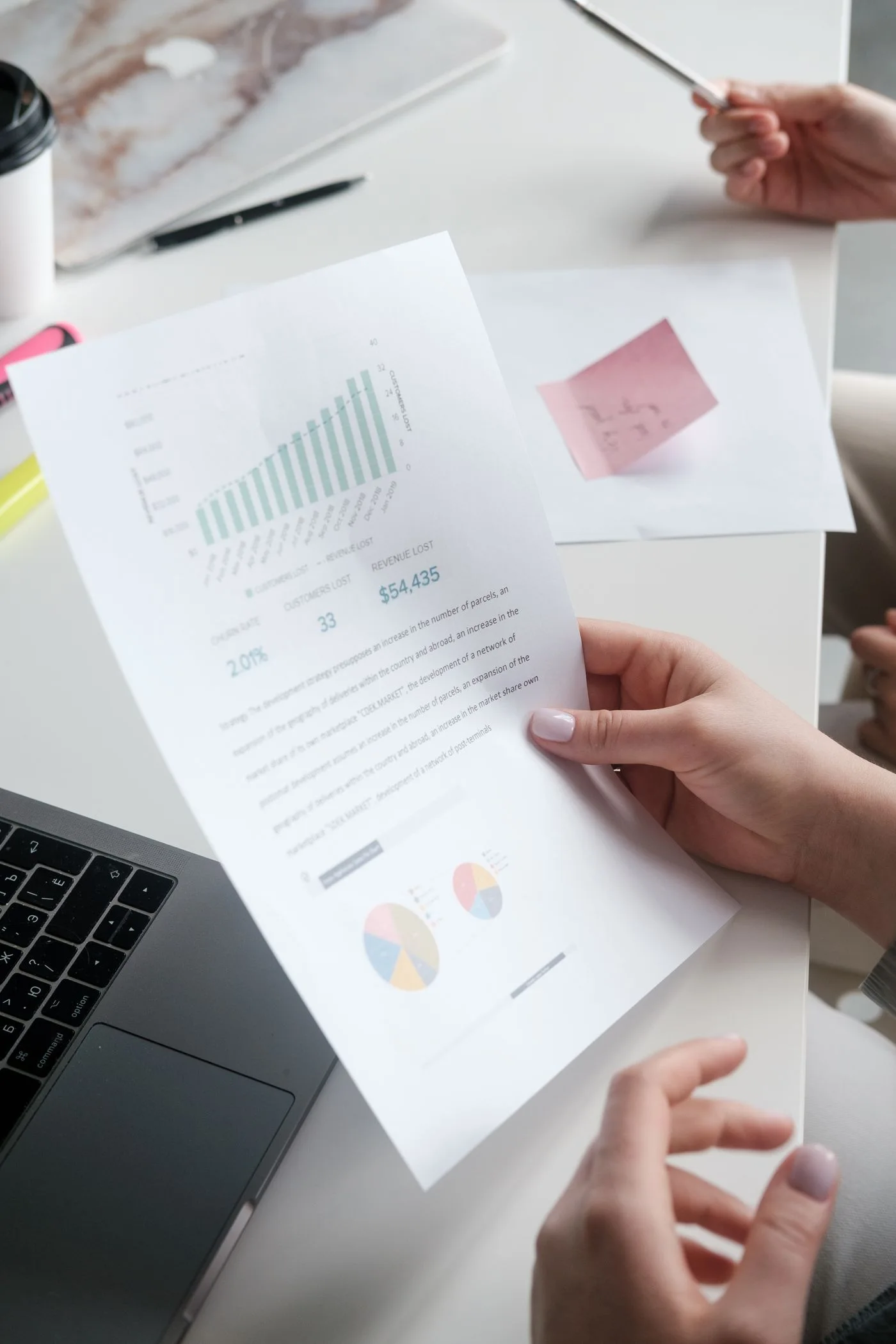 A report with charts being reviewed