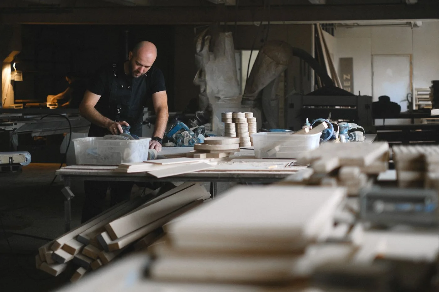 A carpenter working on a wooden component
