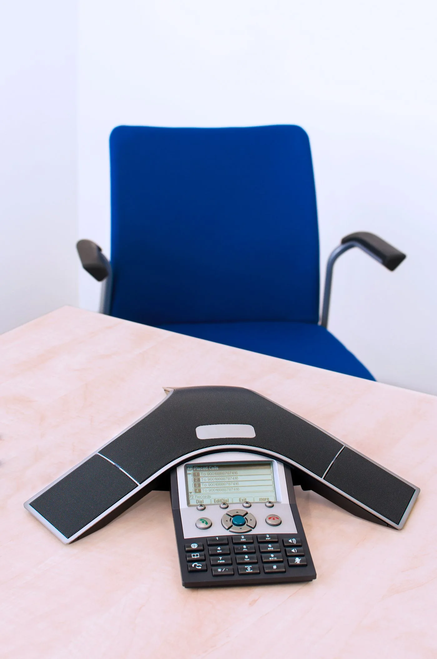 A conference telephone on an office desk