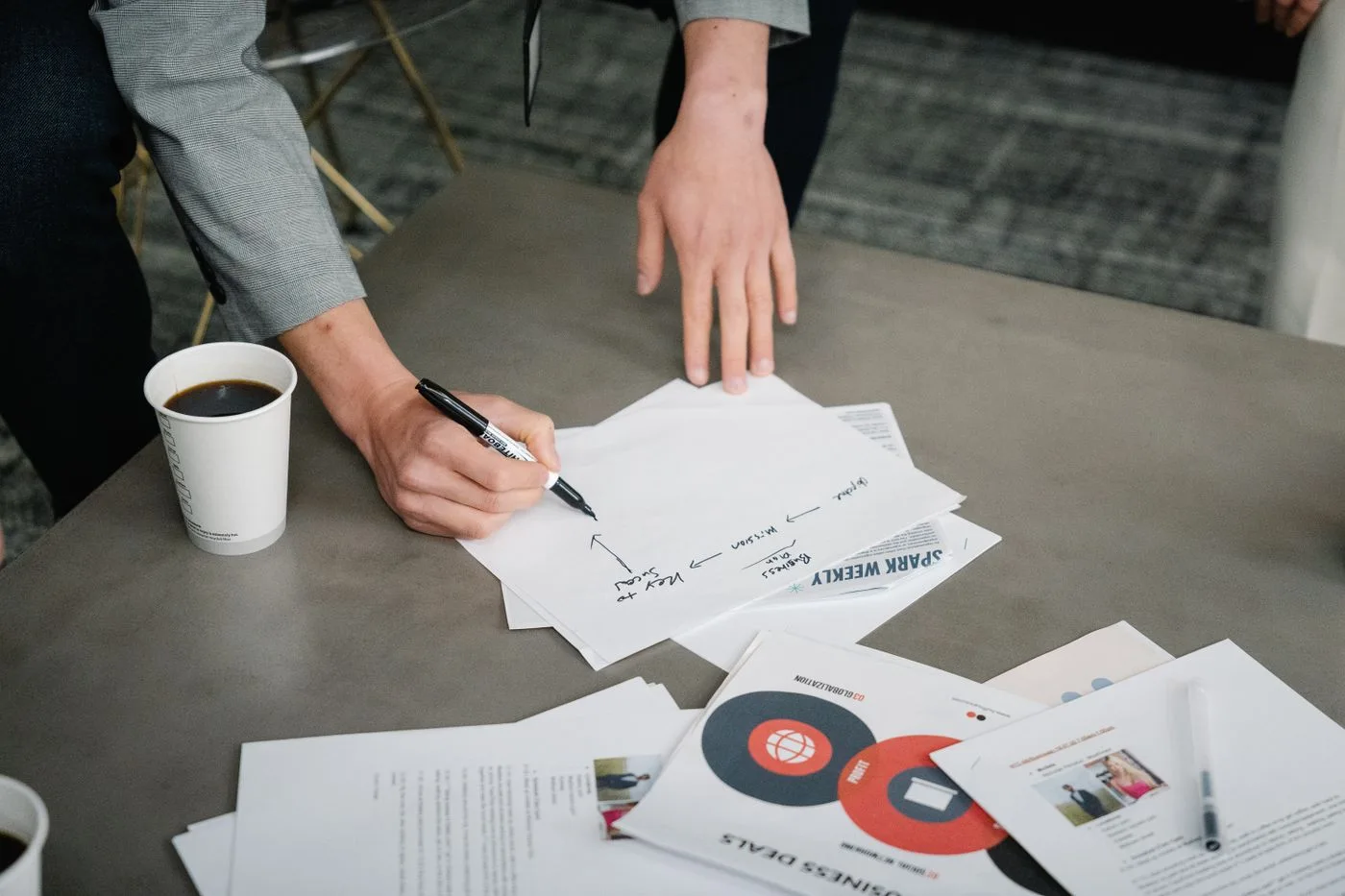 People reviewing and marking documents