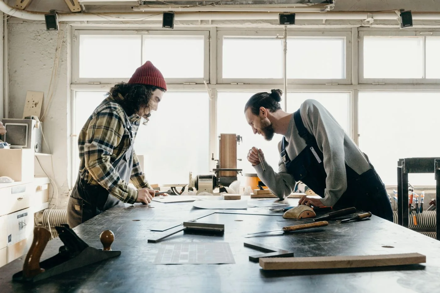 Two craftspeople discussing a workshop project