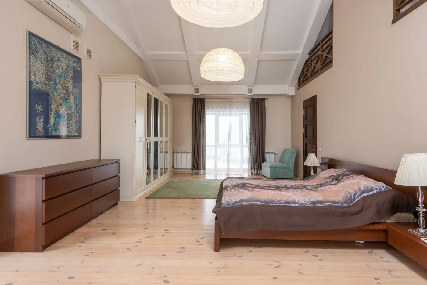 Bedroom with fitted cupboards and wooden furniture