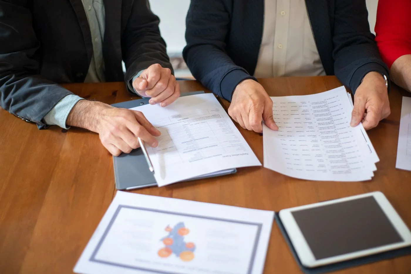 Two people discussing business documents