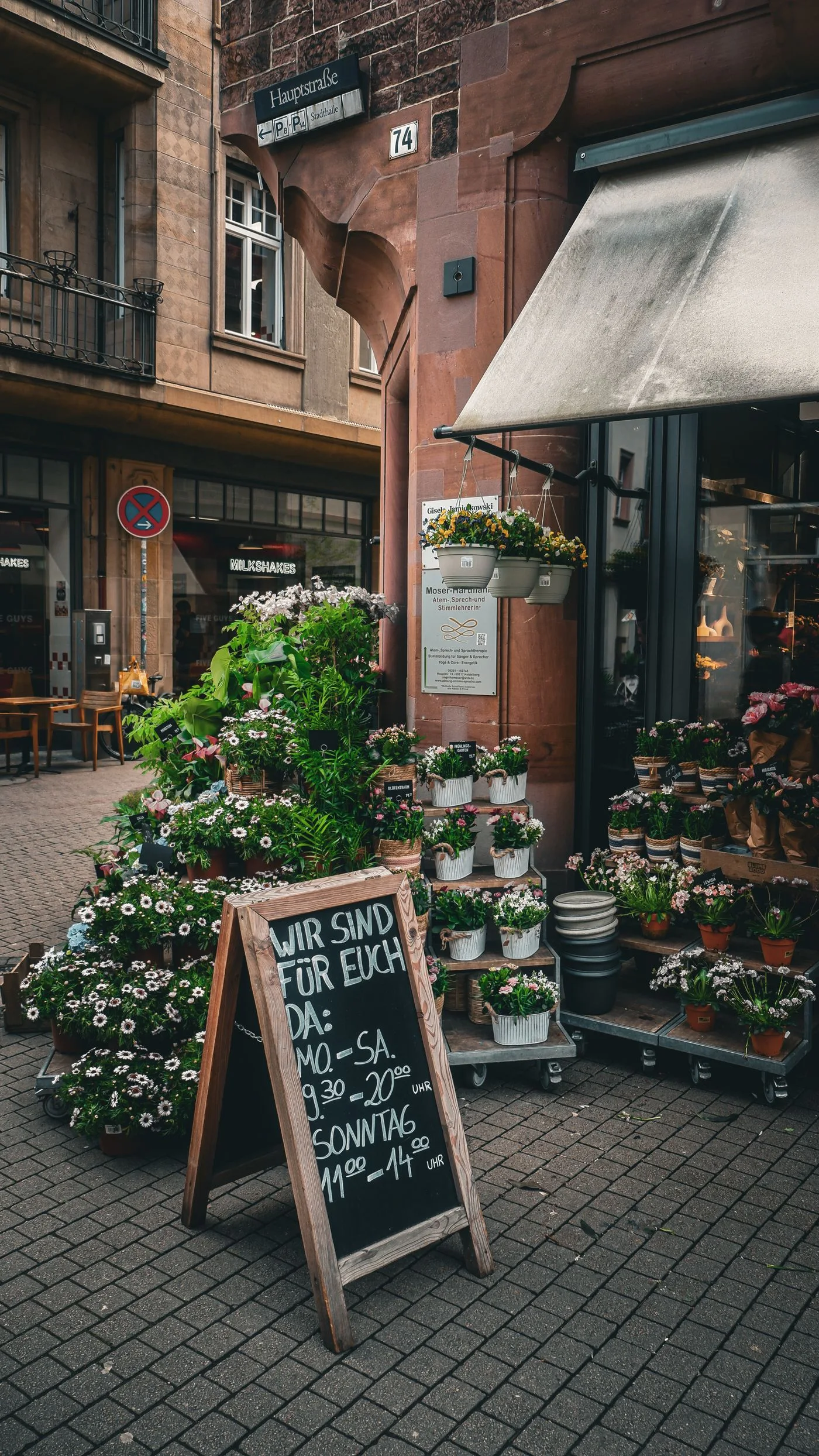 A flower shop with displays outside