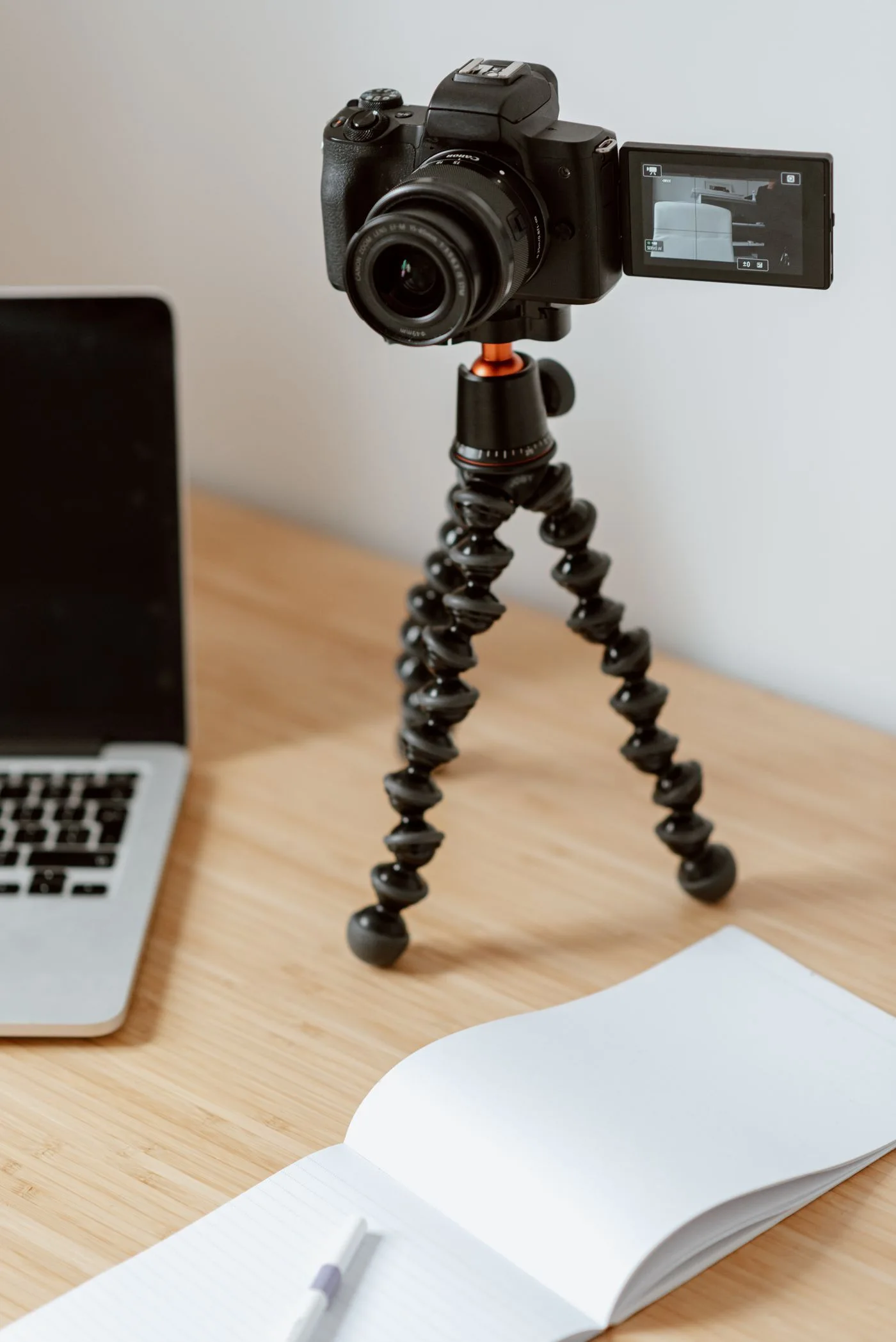 A camera recording beside a laptop
