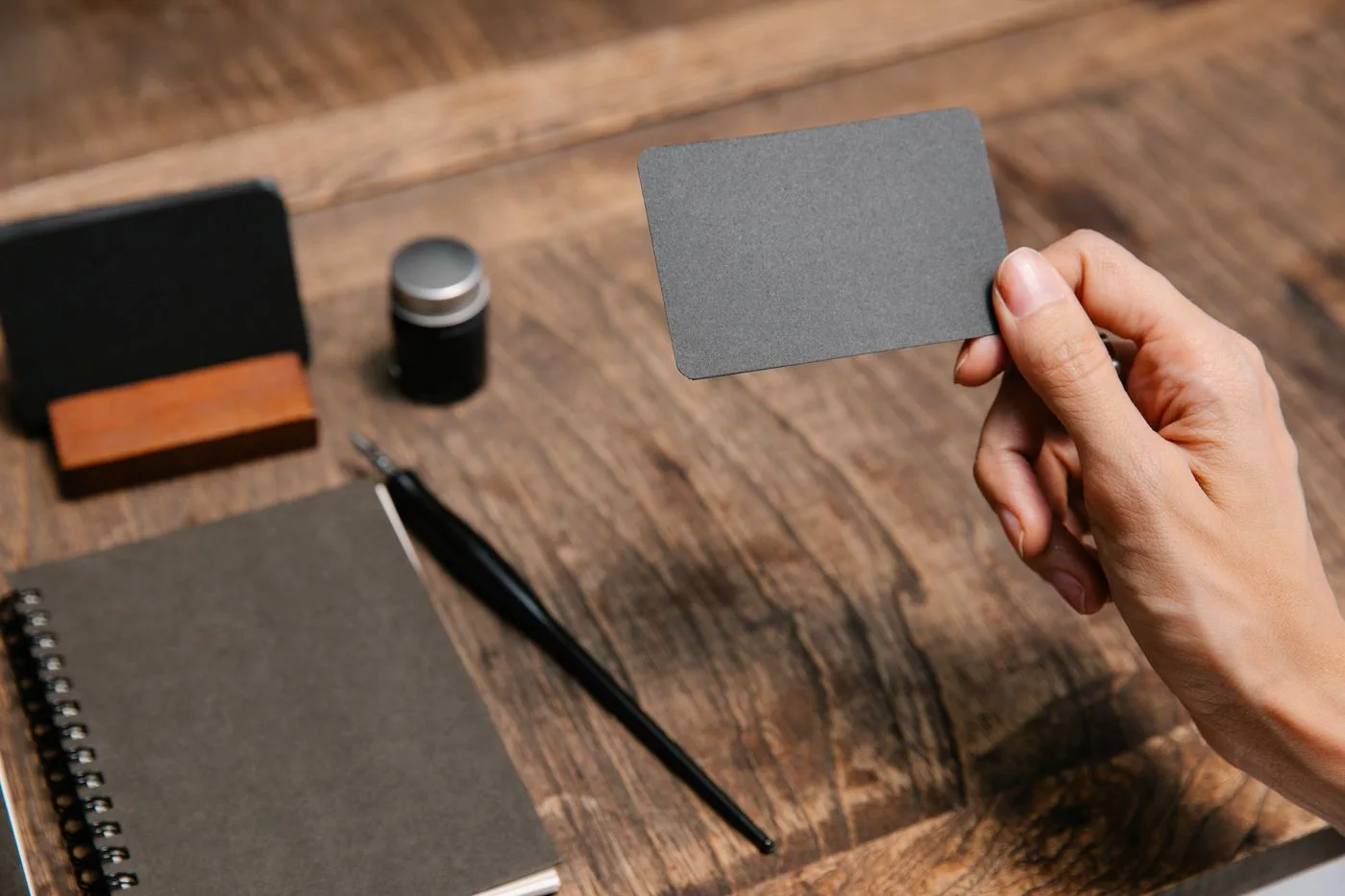 A blank card held above a desk